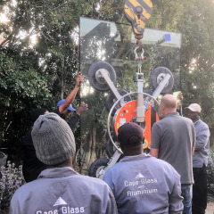 Installing large glass pane with crane