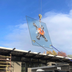 Crane carrying glass pane