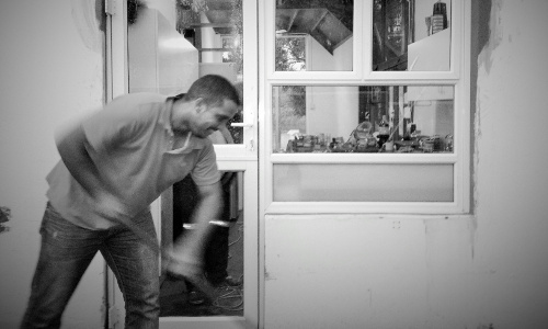 Man working in front of aluminium door